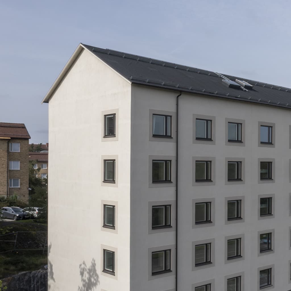 Flerbostadshus med ljus fasad.