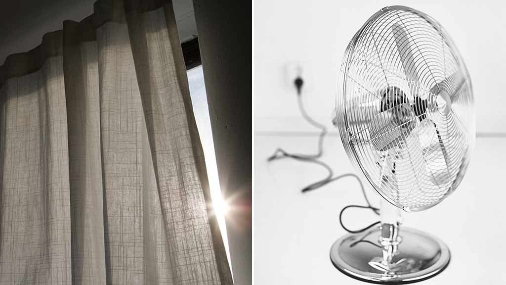 Ett fönster med fördragen gardin med en glipa som släpper in lite solljus och en bordsfläkt inkopplad i ett uttag